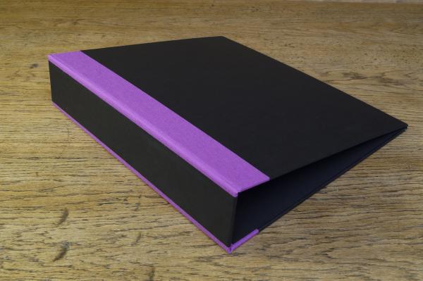 black folder with purple linen corners